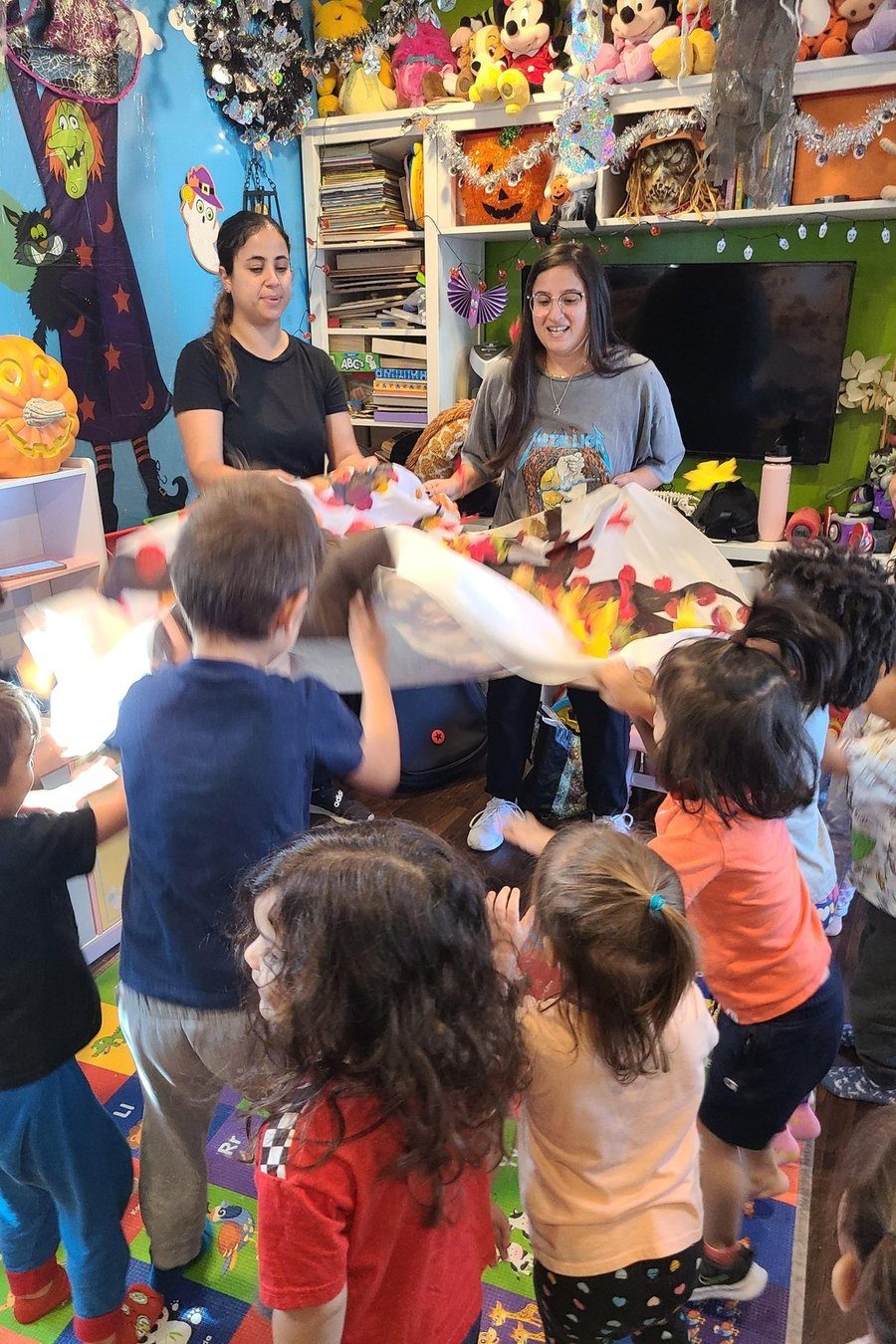 Children participating in a guided music and movement activity at Shila’s Daycare.